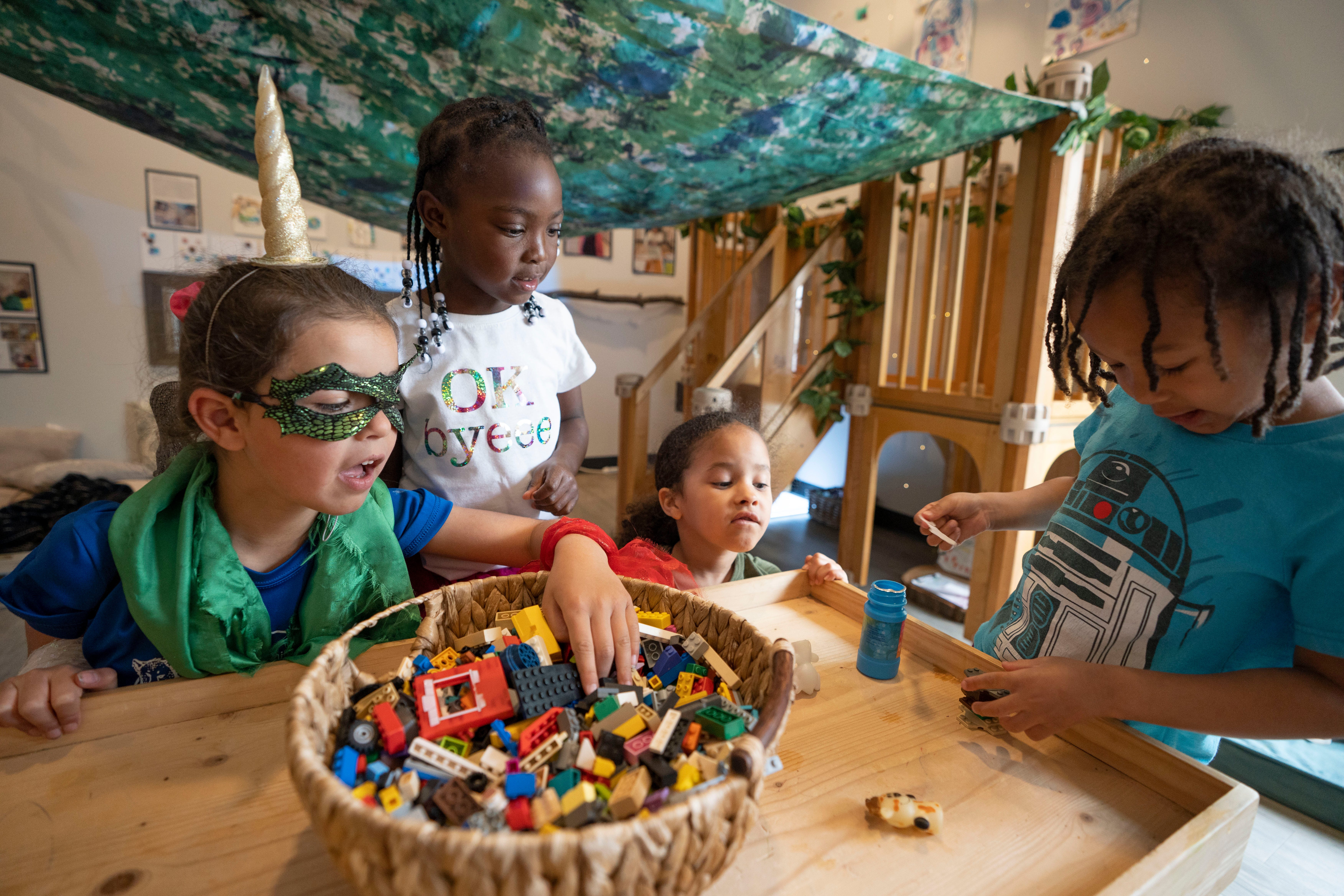 Elena Barragan, Riley Smith, Joshura Davis and Jayceon Bouchillion, all 5, play together at the Urban Sprouts Child Development Center in University City, Mo., on March 29. The center has a waiting list of more than 450 students.