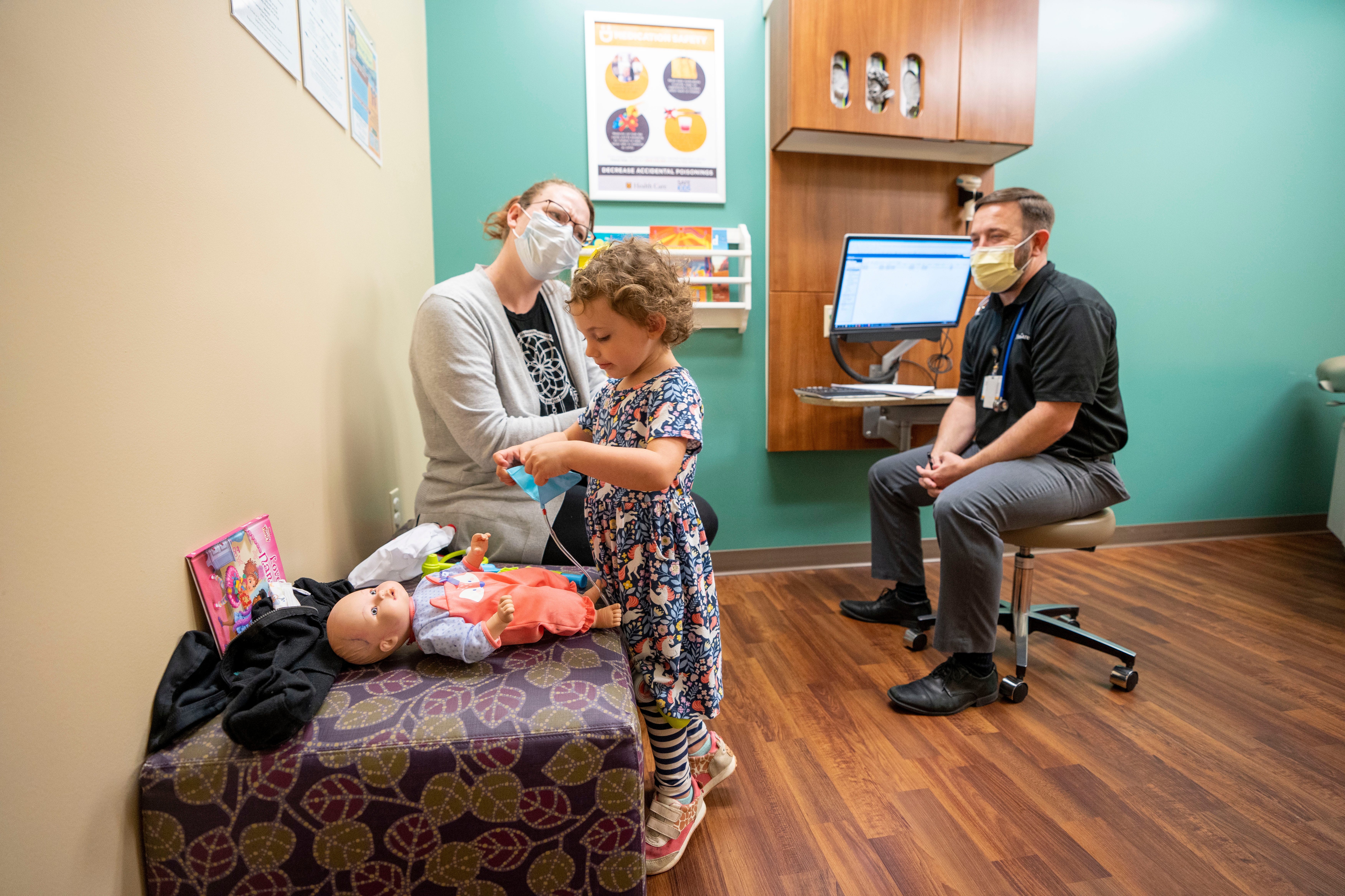 Jessica Mahurin, 32, and Nylah Mancuso, 3, speak with Dr. Nathan Beucke during Nylah’s checkup April 28 in Columbia, Mo.