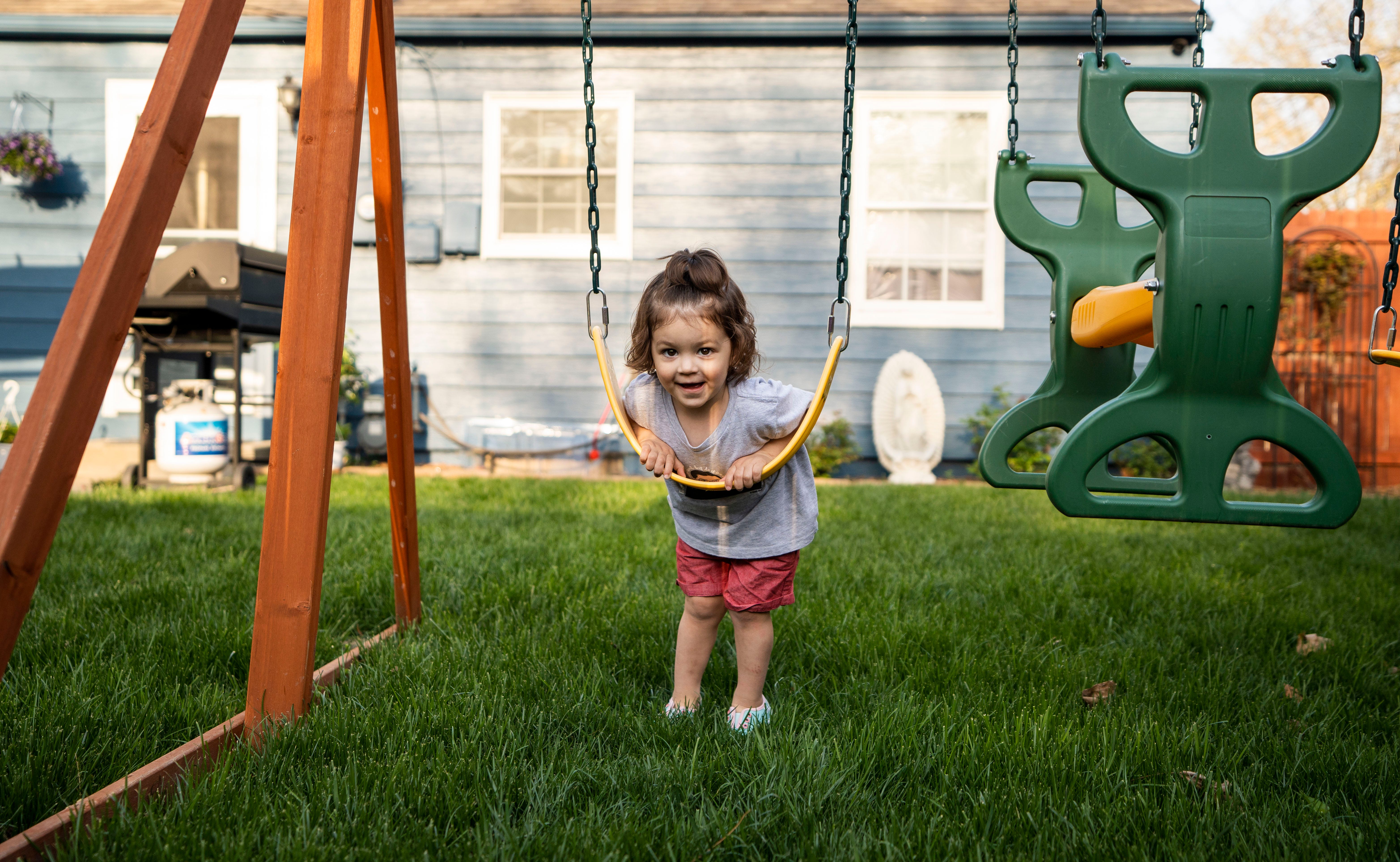 Elvira Grooms, 2, plays in the backyard of her home in Kansas City, Mo., on April 26. Being born during the pandemic has presented challenges for parents who worry about their children’s development.