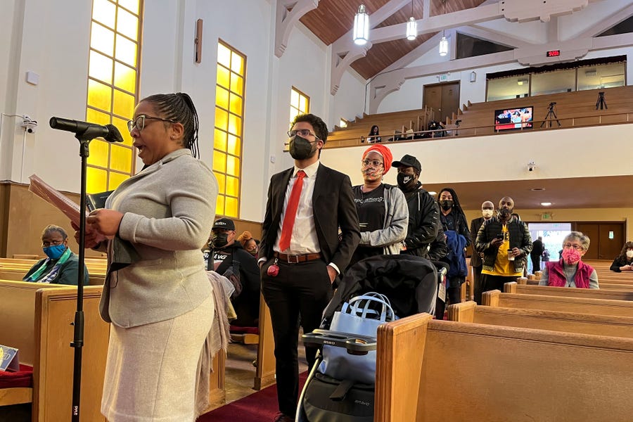 FILE - People line up to speak during a reparations task force meeting at Third Baptist Church in San Francisco on April 13, 2022.