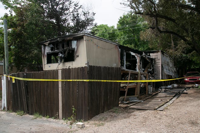Caution tape surrounds the site of a mobile home fire on Thursday. A 4-year-old girl died in the blaze Thursday morning at a North Austin mobile home park, authorities said.