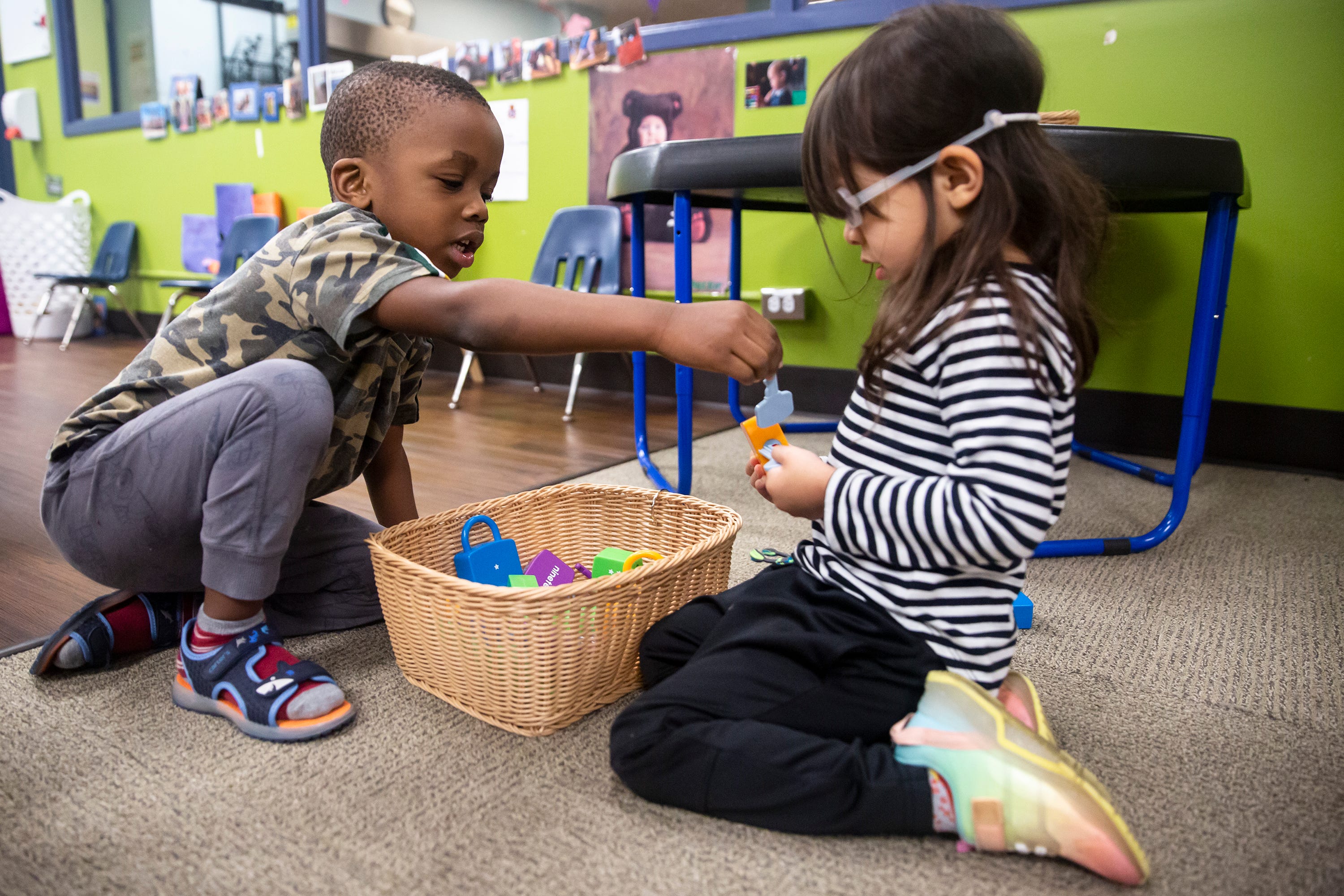 Ose Oriaifo, 3, and Mia Loving, 4, play together at the DMACC Child Development Center, on May 24, 2022, in Ankeny. The child development center is a lab school providing training for early childhood education teachers.
