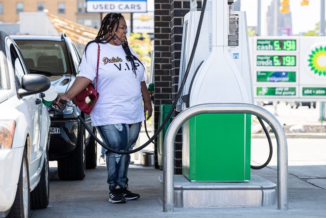Valina Ransom, of Detroit, fills up her Dodge Caliber at a BP gas station on Jefferson Avenue in Detroit on Thursday, June 2, 2022.