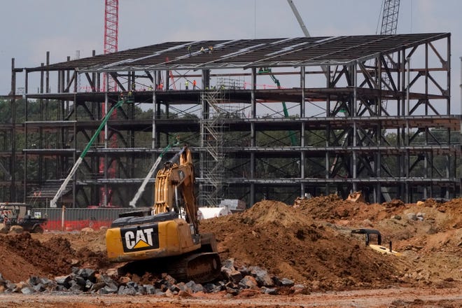 FILE - Construction personnel work on the Carolina Panthers' team headquarters and practice facility Aug. 24, 2021, in Rock Hill, S.C. The Panthers' proposed $800 million practice facility project in Rock Hill is officially dead after team owner David Tepper's real estate company filed for Chapter 11 bankruptcy protection in Delaware on Wednesday night, June 1, 2022. (AP Photo/Chris Carlson, File)