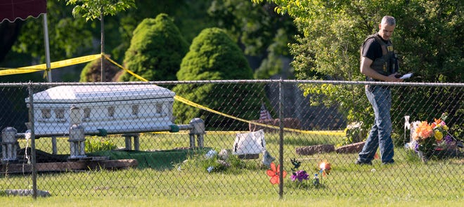 An FBI agent works at the scene of a shooting Thursday at Graceland Cemetery in Racine. An unknown number of people were shot at the cemetery Thursday afternoon during a funeral for Da'Shontay L. King Sr. The shooting occurred at the interment for King who was fatally shot by Racine police May 20.