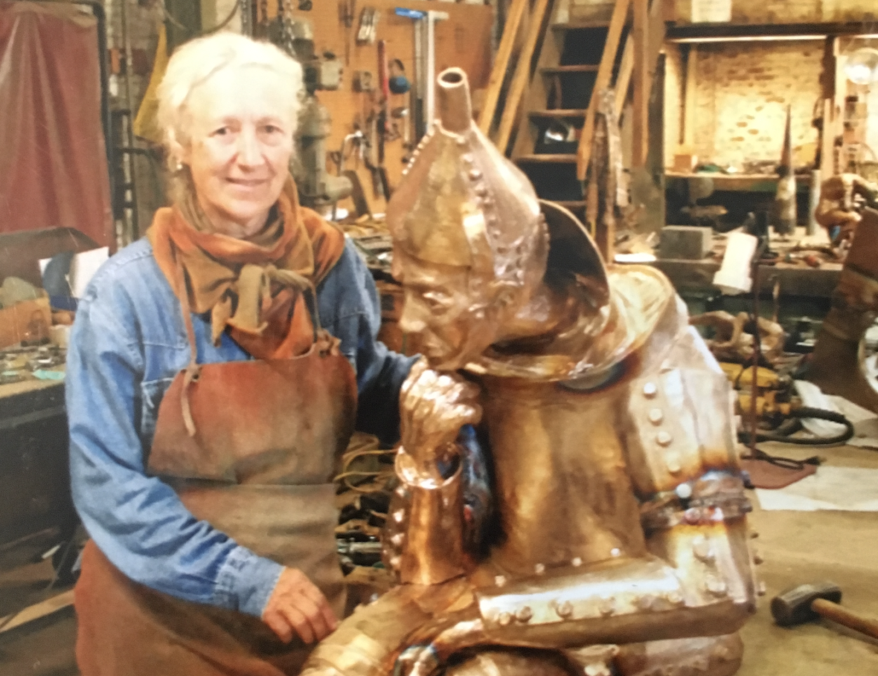 Standing in her Dallastown basement studio, sculptor Lorann Jacobs is seen with her creation, ‘The Tinker,’ one of her best-known sculptures. ‘The Tinker’ sits near the York County Judicial Center in York.