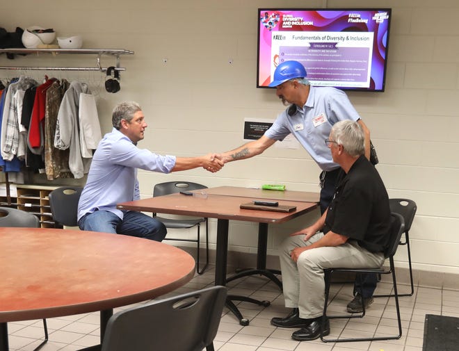 Representative Tim Ryan, left, greets John Pidcock while meeting with employees at Bimbo Bakery's Eastpointe Industrial Park facility. At right is Mark Lee, of Bakery, Confectionery, Tobacco Workers and Grain Millers International Union Local 57.