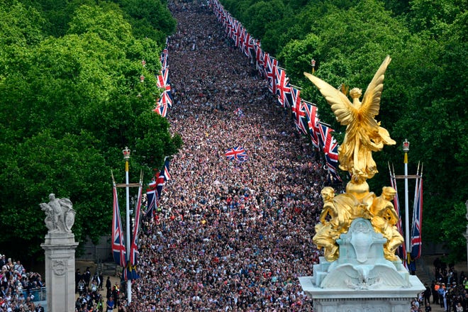 Members of the public fill The Mall ahead of a flypast over Buckingham Palace, during the Trooping the Color in London, Thursday, June 2, 2022.