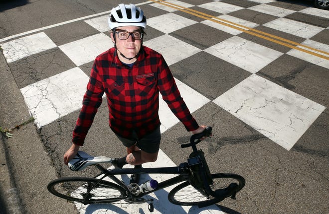Spencer Hackett, race director for Tour de Grandview Cycling Classic, stands June 1 at the finish line for the race which is on First Avenue near Avondale Road.