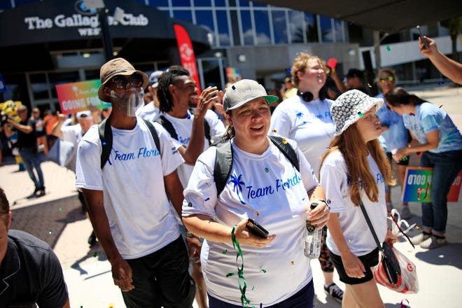 Triathlete Jennifer Hartley, center, and other Special Olympians are paraded to their bus Friday at TIAA Bank Field in Jacksonville for a formal sendoff to the 2022 Special Olympics USA Games. The competition will be through next weekend in Orlando.