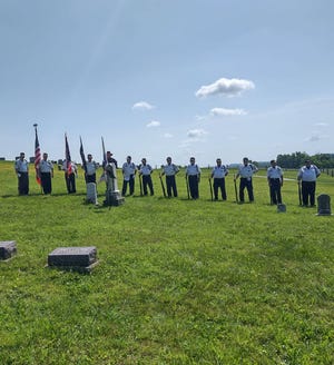 Members of the  Newcomerstown Honor Guard honor John Casteel.