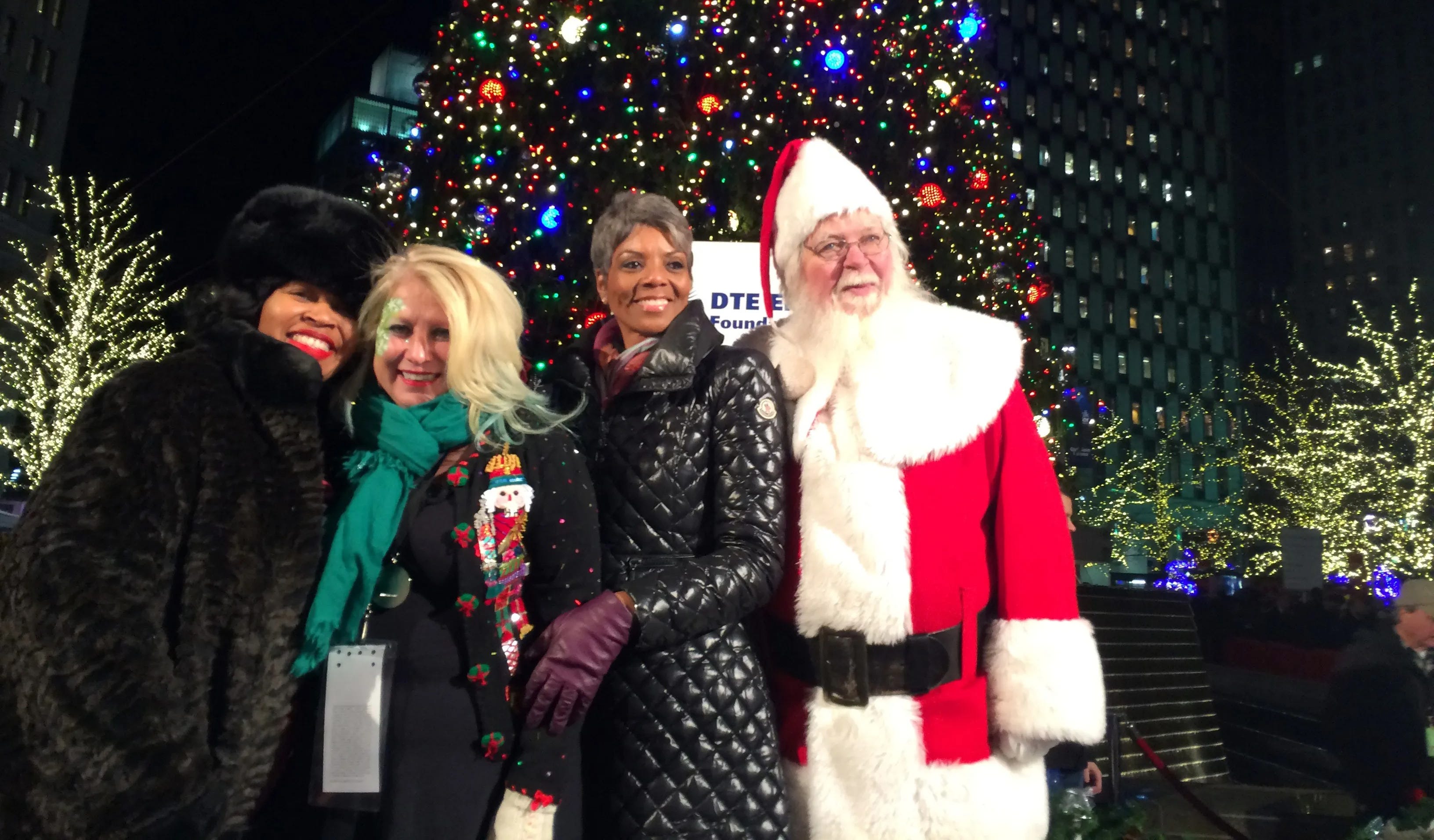 Detroit Councilwoman Brenda Jones, left; Cindy Pasky, CEO and president, Strategic Staffing; Faye Nelson, vice president of public affairs for DTE Energy; and Santa pose for a photo after the tree-lighting ceremony..