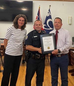 Andrew Kuhnash, center, was sworn in as new part-time officer with the Granville Police Department on June 1 by Mayor Melissa Hartfield, left, and presented with a certificate by Village Manager Herb Koehler, right.