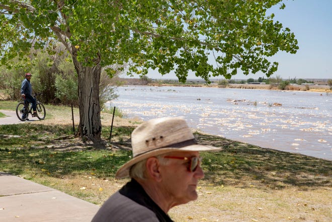 Community members stop to watch the Rio Grande after its return to Las Cruces at La Llorona Park on Friday, June 3, 2022.