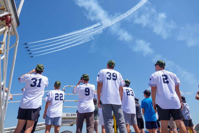 Members of the Blue Wahoos, Anthony Maldonado (31), Andrew McInvale (22), Griffin Conine (9), Brady Puckett (39), Colton Hock (23) and Troy Johnston (2) watch the Blue Angels perform at practice Wednesday at Naval Air Station-Pensacola.