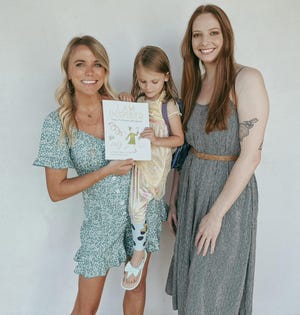 Sisters Dylan Mills (left) and Shelby Koehler with Mills’ daughter, who inspired the main character in the children's book “I Am Inspired: A Day of Children's Affirmations.” Mills and Koehler are the book's author and illustrator, respectively.