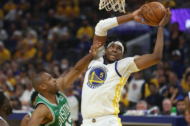 Golden State Warriors center Kevon Looney (5) drives against Boston Celtics center Al Horford during the first half of Game 1 of the NBA basketball finals in San Francisco, Thursday, June 2, 2022.