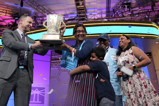 Harini Logan, 14, holds a trophy after winning the 2022 Scripps National Spelling Bee.