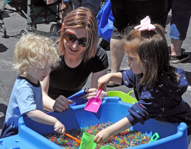 Asher Call, Makayla Connock and Charlotte Chenevey play in this pit of marbles Saturday during Kids Day in downtown Wooster.