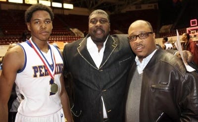 Justin Tillman, then a basketball player for Detroit Pershing, stands with his father John (center) and cousin.
