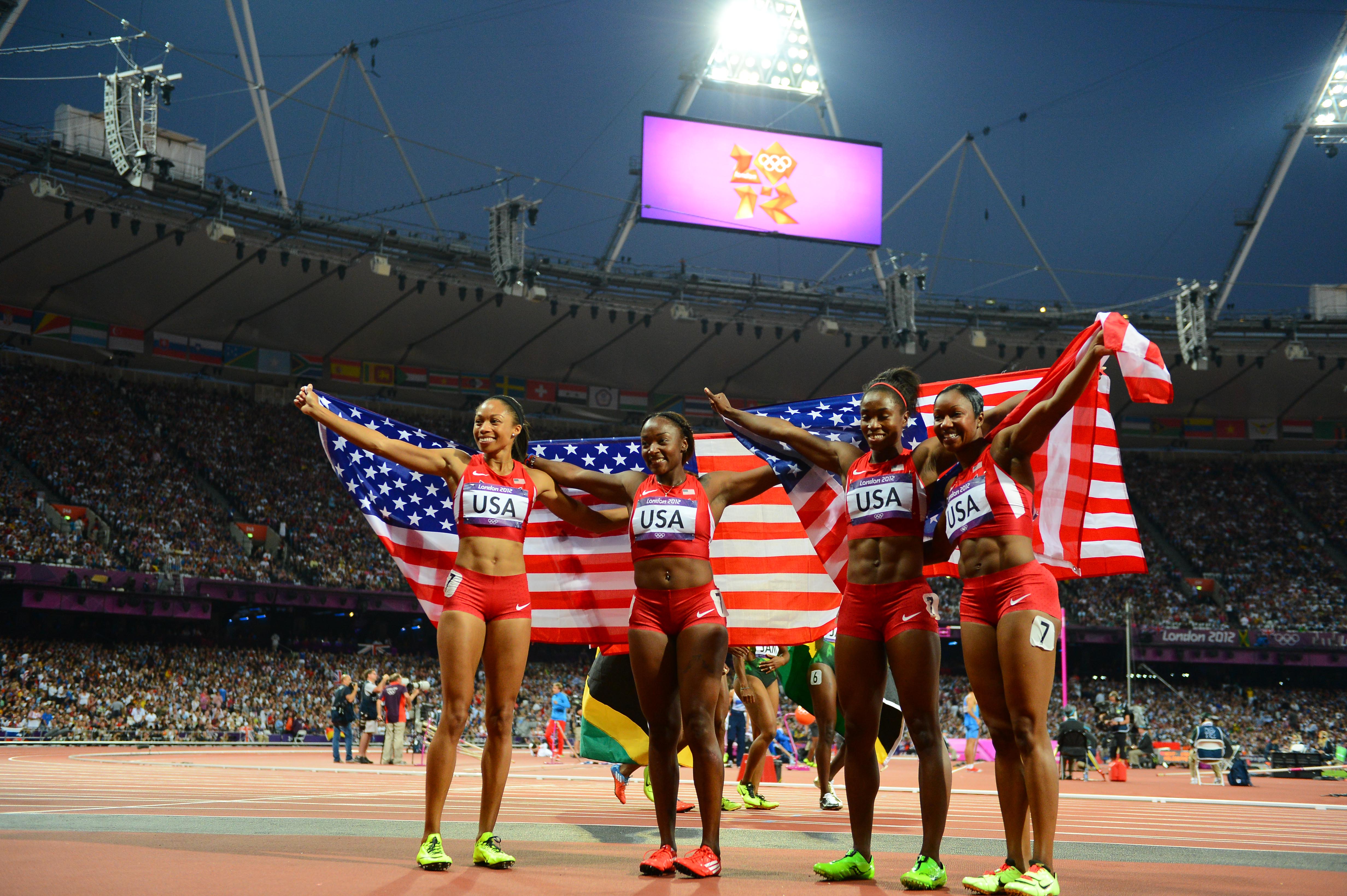 The women's 4x100 relay team of (left to right) Allyson Felix, Bianca Knight, Tianna Madison and Carmelita Jeter celebrate after winning gold at the 2012 Olympics.