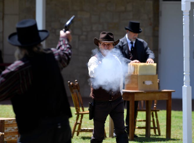 Saloon manager Zemo Hemphill, played by Michael McCormick (left), is shot by Deputy Sheriff Walter Collins, portrayed by Paul Seals, during  the Saturday Shootouts performance at Frontier Texas!