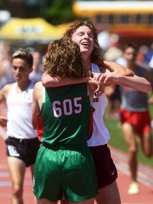 John Glenn senior Chris Tooms hugs Barnesville's Tyler Jenkins after winning the 3200 meters during the Division II state track and field meet on Saturday at Ohio State's Jesse Owens Memorial Stadium in Columbus. Tooms finished at 9:14.4, more than two seconds ahead of runner-up Joshuah Taylor, of Bryan. He is the Muskies' second state champion in the last five years.