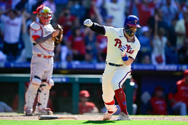 The Phillies' Bryce Harper reacts after hitting a game-tying grand slam in the eighth inning Sunday against the Angels.