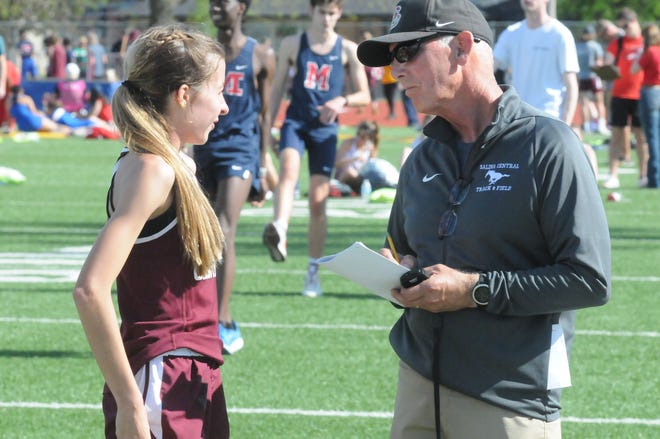Salina Central track and field coach Rick O'Neill talks to freshman Addison Renfro during the Central Invitational Friday, May 6, 2022 at Salina Stadium. O'Neill retired from coaching at Central after the conclusion of the spring season.