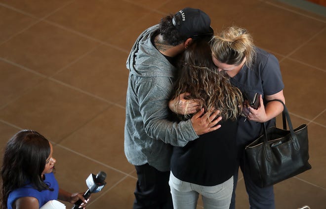 Carly Schaap, center, is embraced by friends and family after talking to the media about her son, Hunter, on Tuesday. The same day, three men were charged in Kitsap County Superior Court in the murder of her son and three others ⁠— Johnny Careaga, 43; Christale Lynn Careaga, 37 and Johnathon F. Higgins, 16 ⁠—  on Jan. 27, 2017.