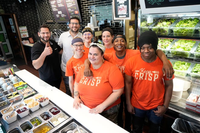 Grassroots Salad Company owners Peter, left and Louis Liapis with their employees, from lower center clockwise, Cierra Wood, Kari Toth, Taylor Towery, Faith Roark, Ashanti Whitfield, and Armond Seals at Grassroots Salad Company in the Chase Tower on North Water Street in Milwaukee on Tuesday, June 7, 2022. In Milwaukee, there were 6 % more restaurants at the end of 2021 than in 2019. But inflation and supply chain disruptions are presenting new challenges for the restaurant industry.