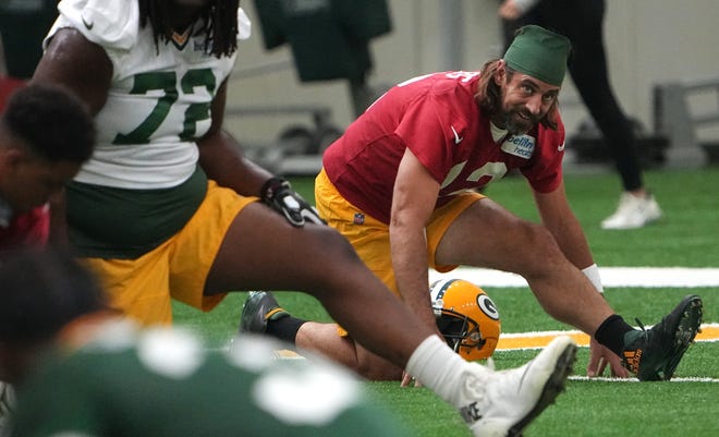 Quarterback Aaron Rodgers (12) stretches during the Packers' minicamp Tuesday.