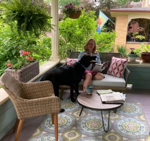Holly Christensen relaxes on her porch with her dog Otto.