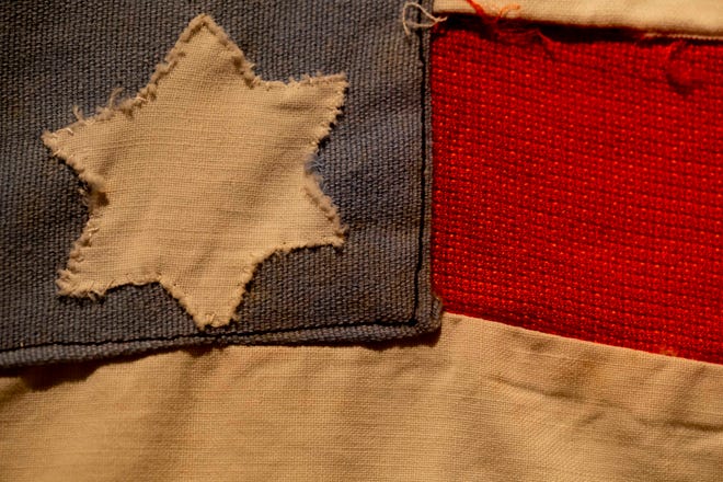 A flag stitched by Polish prisoners in 1945 at the Nordhausen Concentration Camp during World War II displays, Wednesday, June 8, 2022, in The John Ebling Veteran Art Gallery at American Legion Post No. 38 in Fort Myers, Fla.