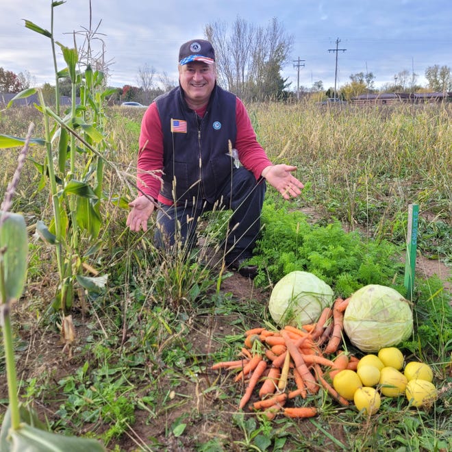 David Lee Schneider of Oconto show just a few of the vegetables grown in a Howard-Suamico School District. Schneider recently received one of two 2022 AmeriCorps Members of the Year at the Governor's Service Awards program in Madison for his efforts in the Farm to School Program.