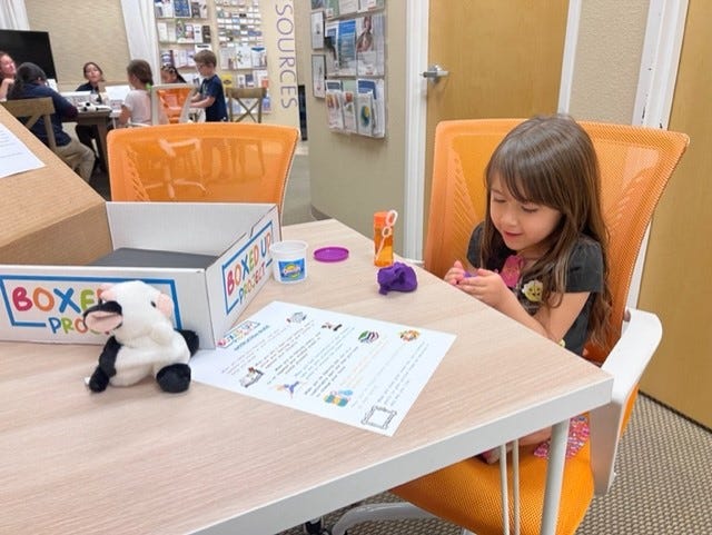 A girl plays with items in a grief box from the Boxed Up Project.