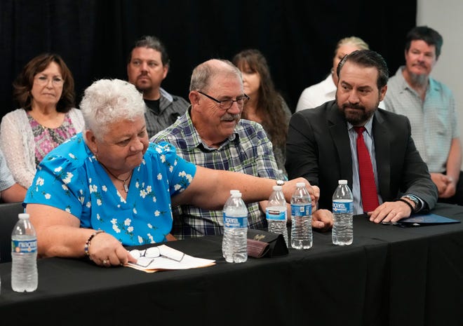 Debbie Carlson, mother of Vicki Lynne Hoskinson, reaches out for the hand of Arizona Attorney General Mark Brnovich after the execution by lethal injection of Frank Atwood at the Arizona State Prison in Florence on June 8, 2022. Atwood was sentenced to death in 1987 for the kidnapping and murder of 8-year-old Vicki Lynne Hoskinson.