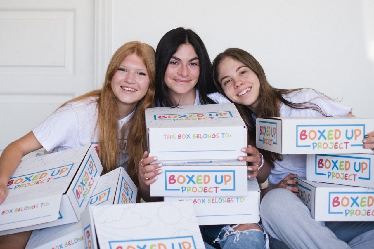 Sinclaire Tzick, Milan Coraggio-Sewell and Elina Ferrigno display boxes from the Boxed Up Project.