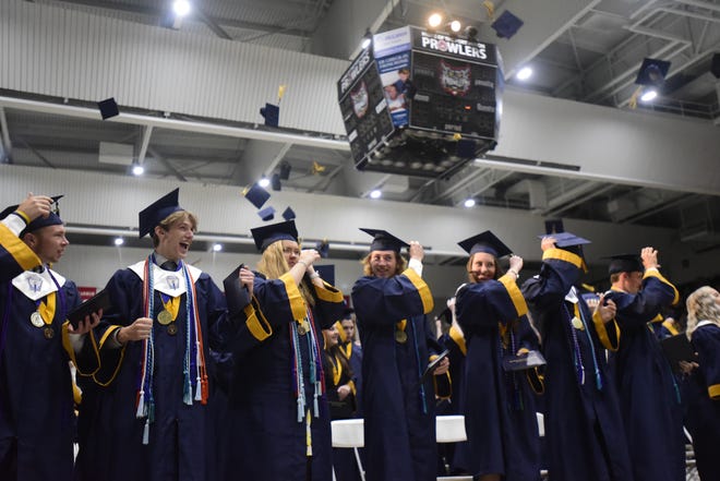 Graduates toss their mortarboards during the Port Huron Northern High School commencement ceremony at McMorran Arena in Port Huron on Tuesday, June 7, 2022.