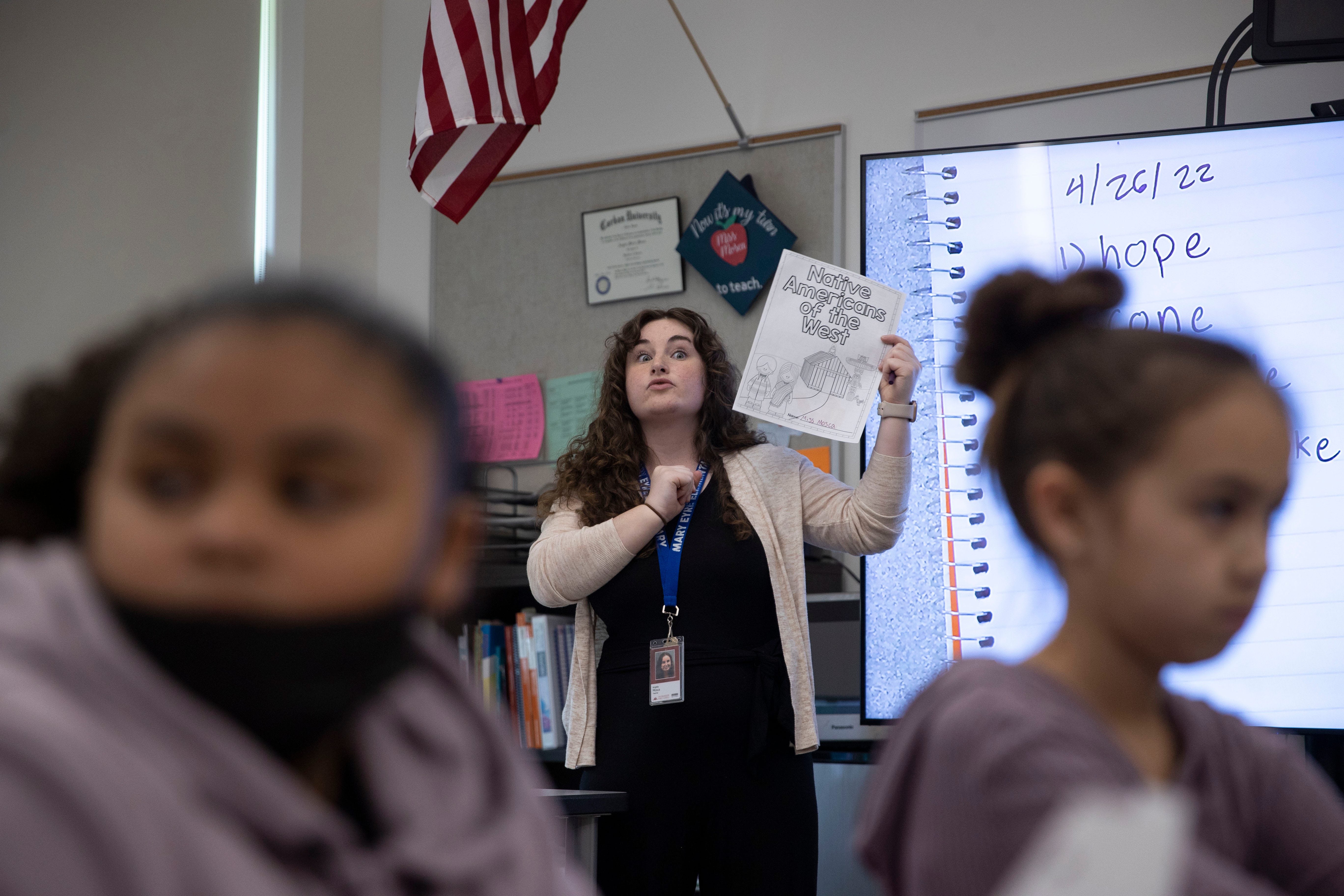 Angela Mosca instructs students to get out a reading guide during a reading skills lesson at Mary Eyre Elementary School in Salem in April.