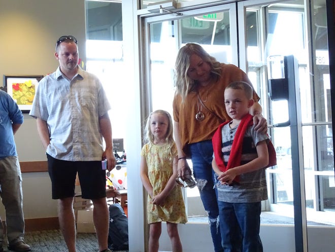 Conlee Handshy (right) is surprised at the Zanesville Panera Bread with a trip to Disney World. He is joined by his father Bryan Handshy (left), sister Bexlee and mother Kristina.