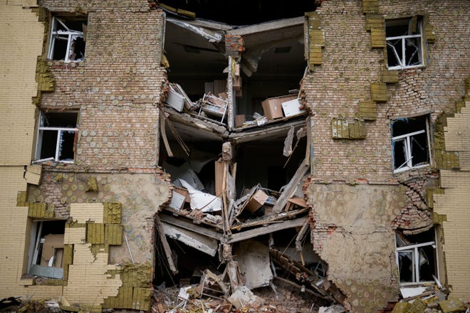 Debris hangs from a residential building heavily damaged in a Russian bombing in Bakhmut, eastern Ukraine. Fighting has raged around Lysychansk and neighboring Sievierodonetsk, the last major cities under Ukrainian control in Luhansk region.