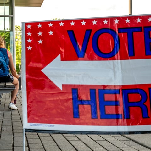 A sign directs to the Ames Public Library on Prima