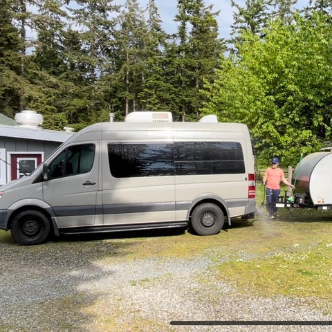 The author's husband washes their Sprinter van and