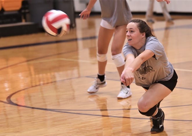 Moran grad Johnnie Hise lunges for a dig during North squad practice on Wednesday at Wylie's Bulldog Gym.