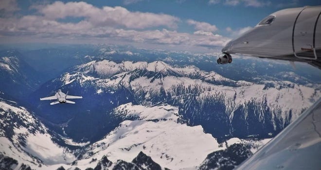 Embraer Phenom 300E tracks fighters on the mountain range during filming "Top Gun: Maverick."