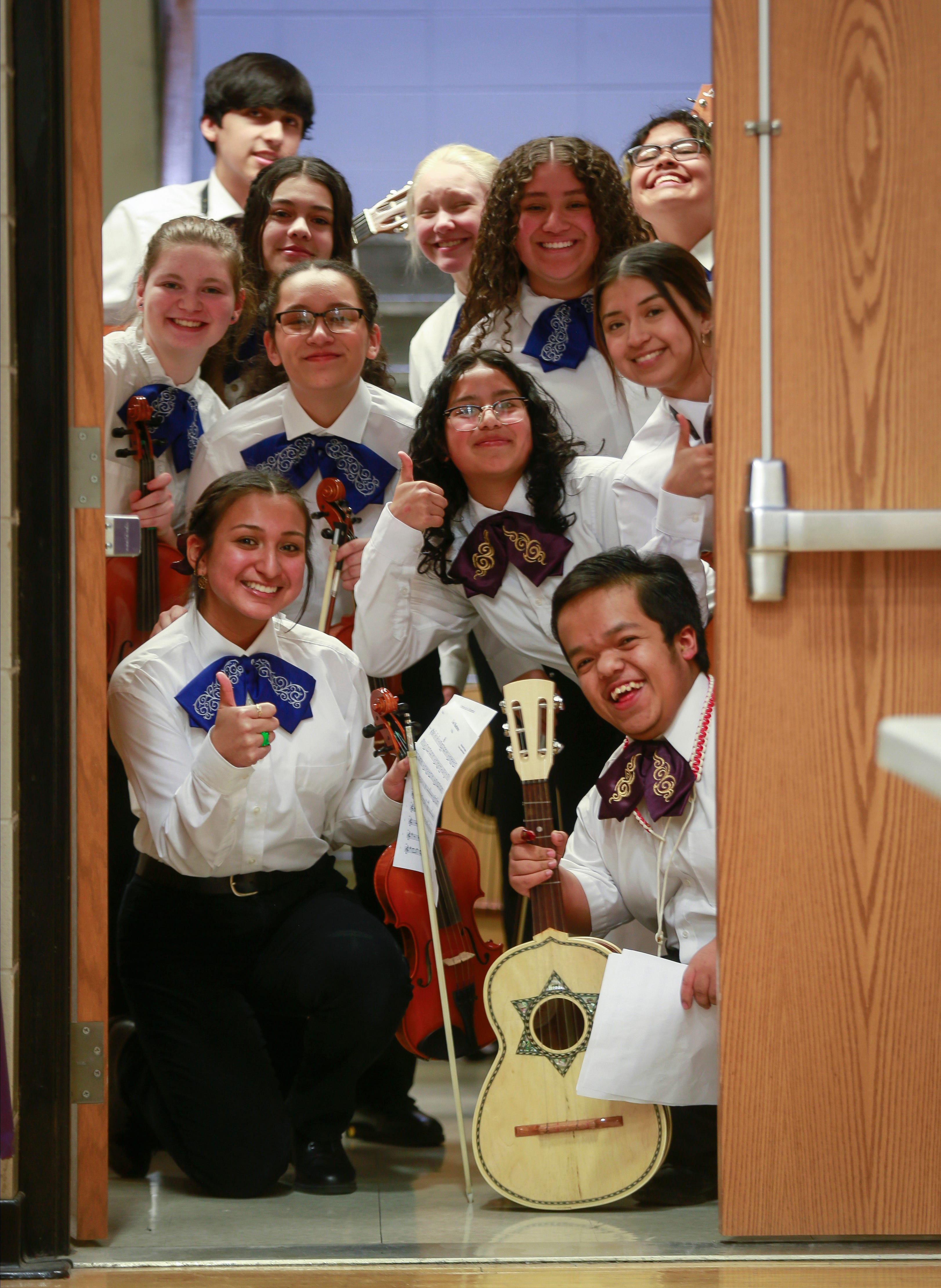 Members of the Denison High School mariachi ensemble pose for a group photo in a doorway to the high school gymnasium prior to the start of the 2022 Fiesta Mariachi celebration.