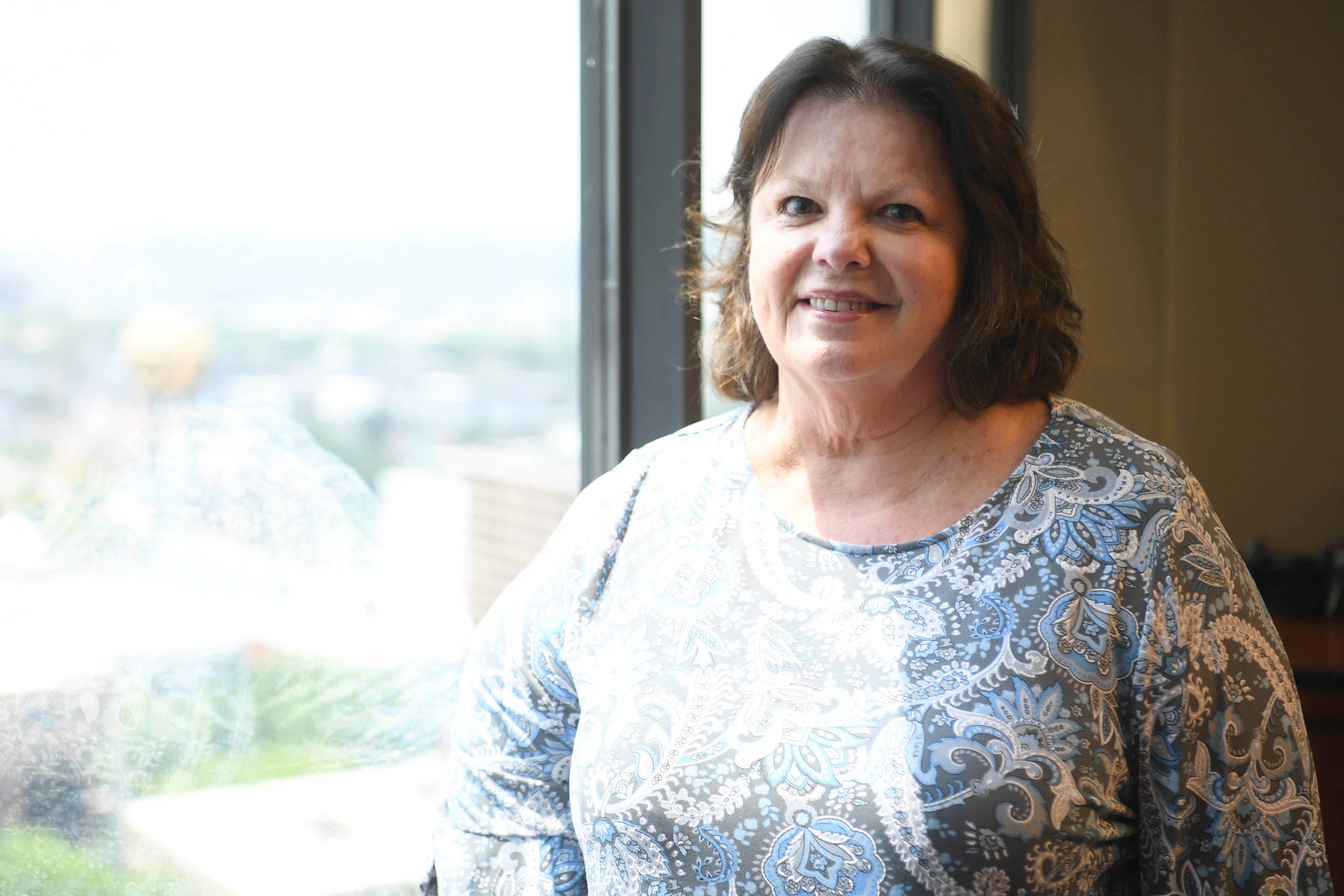 Legal assistant Linda Crisp of Kramer-Rayson poses for a photo in their Gay Street office, Thursday, May 19, 2022.