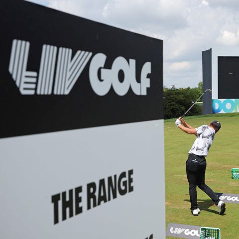 Players practice on the driving range ahead of the
