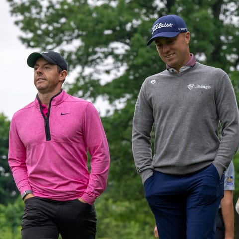 Rory McIlroy, left, and Justin Thomas walk down th
